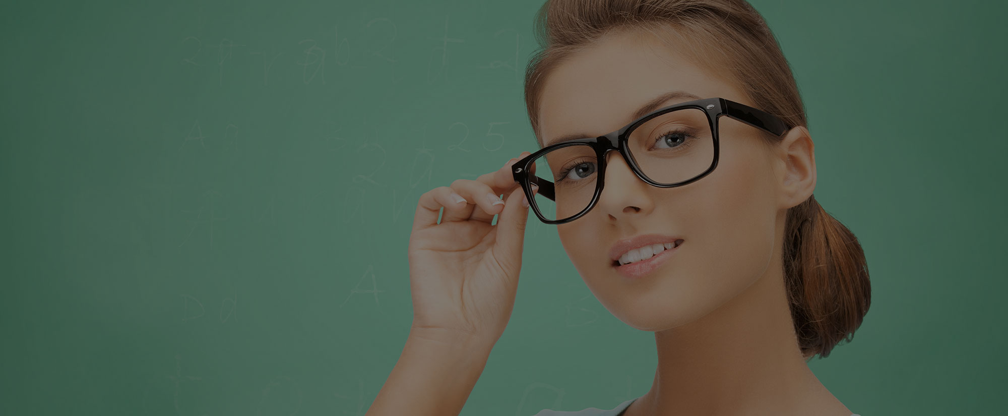 Smiling woman adjusting a pair of black eyeglass frames
